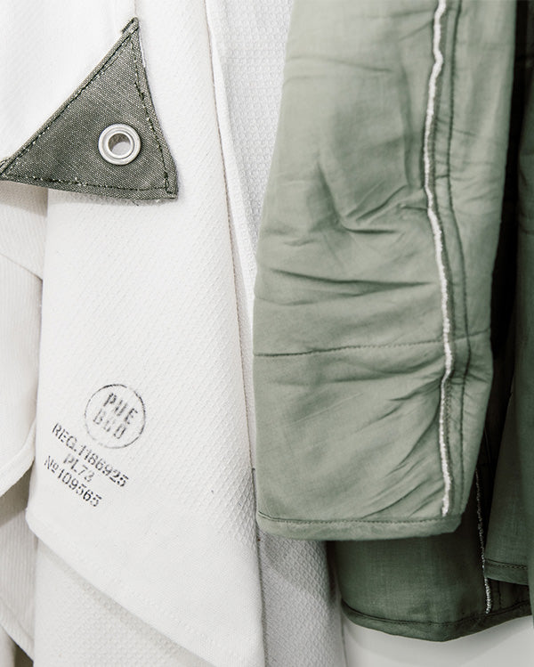 Close up of Puebco white towel and green jacket